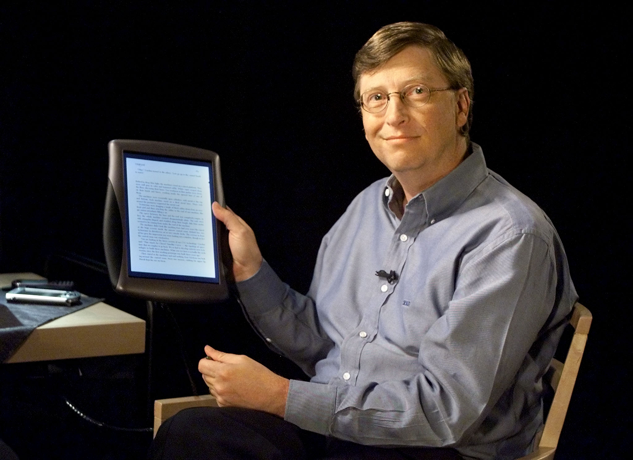 Bill Gates, Chairman and Chief Software Architect of Microsoft, holds a tablet PC during Forum 2000,..