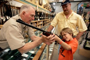 McConathy holds a hunting rifle with a short stock at the Cabela's store in Fort Worth